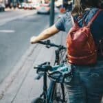 person-walking-bike-on-sidewalk